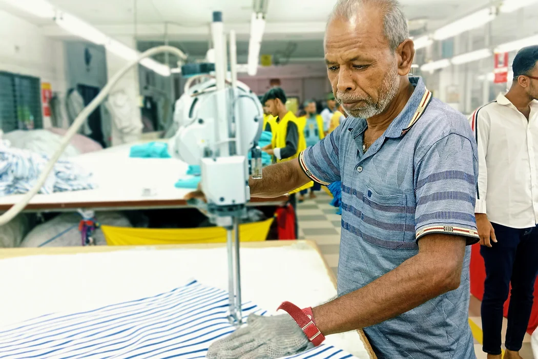 An operator cutting fabric at Shristy Fashion Ltd.