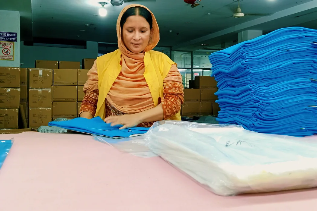 A worker folding garments in the packing area at Shristy Fashion Ltd.
